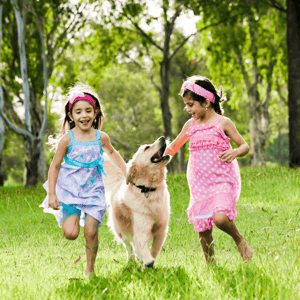 home-buying-tips-pet-owners-two-girls-running-with-dog-image.png