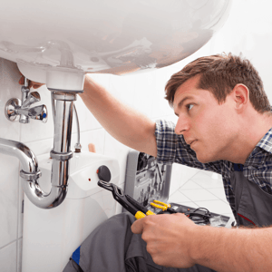 understanding-new-home-warranty-in-alberta-builder-fixing-plumbing-image.png