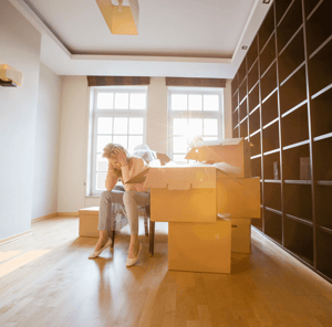 Things to NOT Do When Moving Into Your New Home Woman Cardboard Boxes Image